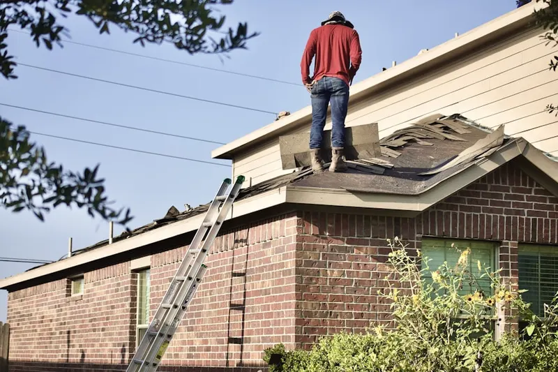 Professional roofer working on a residential roof in Hines